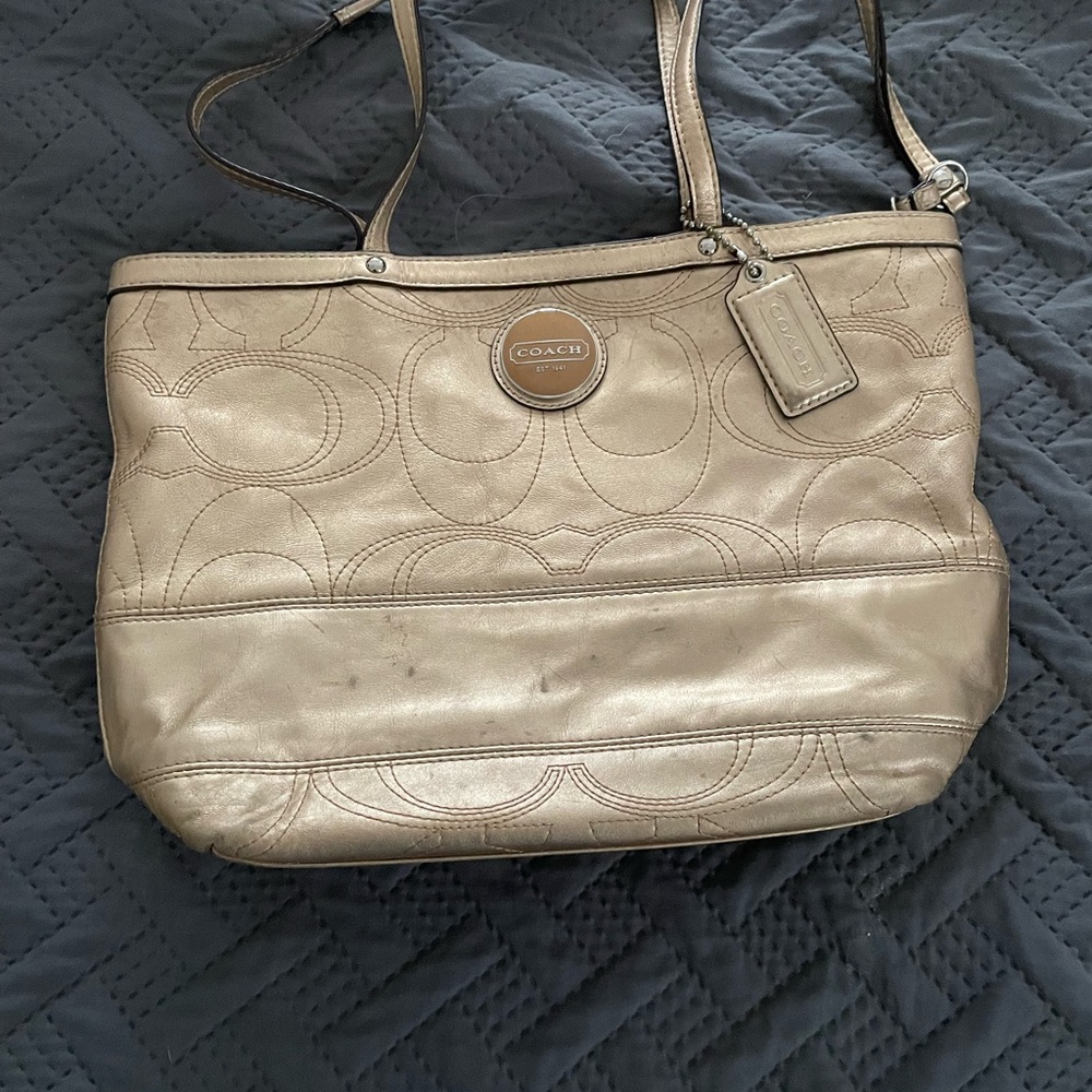 Metallic gold coach purse. Does show signs of wear, but still super cute!